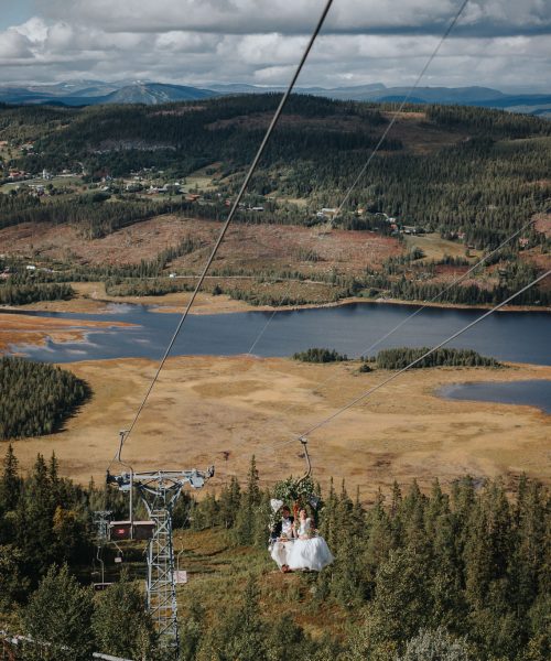 Brudpar kommer i skidlift under sitt fjällbröllop